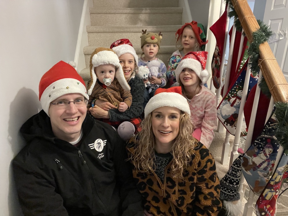 Family photo taken Christmas 2021 on the stairs before a cookie drop-off run